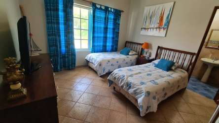 Outdoor covered terrace with BBQ, lounge area overlooking garden villa Coronado Golf Resort