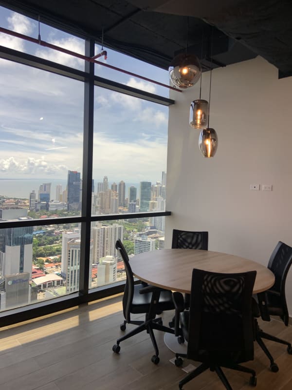 Bright open workspace with workstations and large windows inside PH BICSA Tower Panama