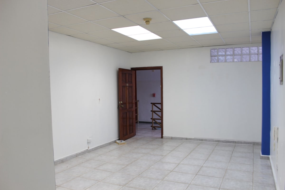 Empty office unit with tiled floor and blue accent wall at PH Centro Empresarial Panama City