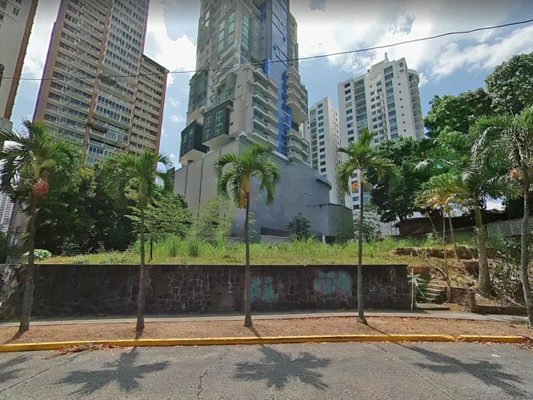 City street view with palm trees and modern buildings surrounding the development lot El Cangrejo Panama City