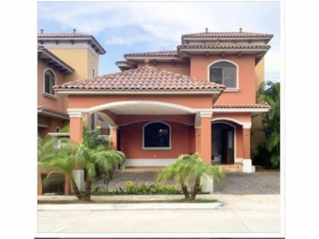 Two-story Mediterranean house with clay tile roof, palm trees, covered carport, Costa Linda Costa Sur Panama