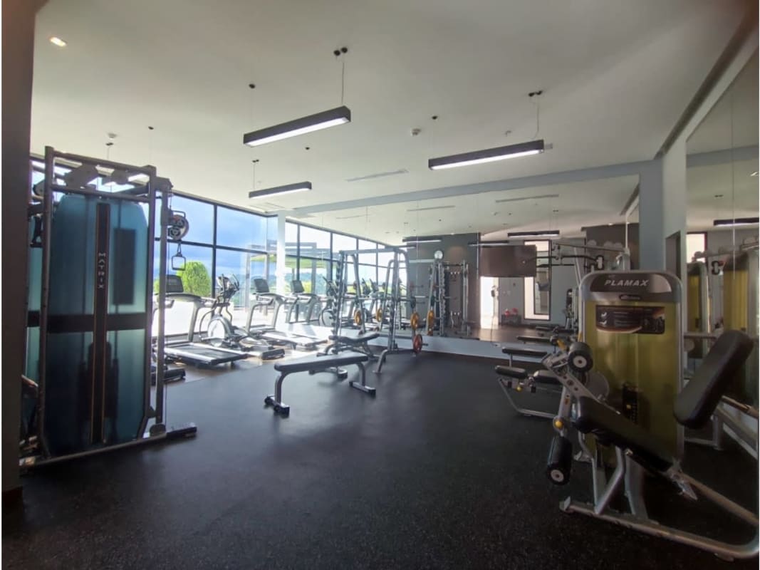 Large open-plan living and dining area with windows and balcony access in PH Portofino Tower Betania Panama