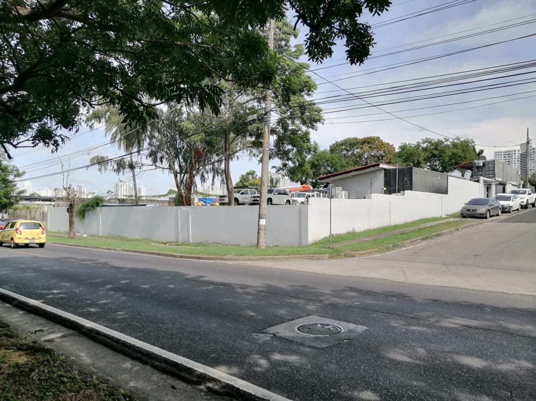 Perimeter wall with gated entry, trees and cars at Avenida Santa Elena Parque Lefevre Panama