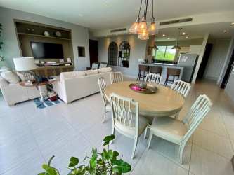 Bright open-concept living dining area with large sliding doors to balcony ocean view in PH Barcovento Punta Barco