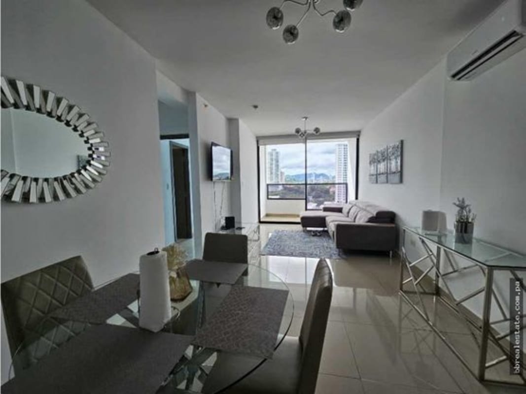 Kitchen with black countertops, appliances and laundry area in PH Canvas Tower Panama City