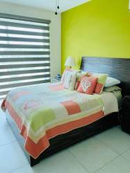 Open plan living area with bright windows, balcony access and ocean view PH Quarry Heights Bijao beach apartment Panama