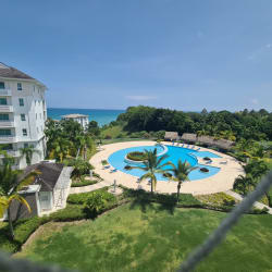 Infinity resort pools surrounded by palm trees and ocean views at Bijao Beach Club Panama