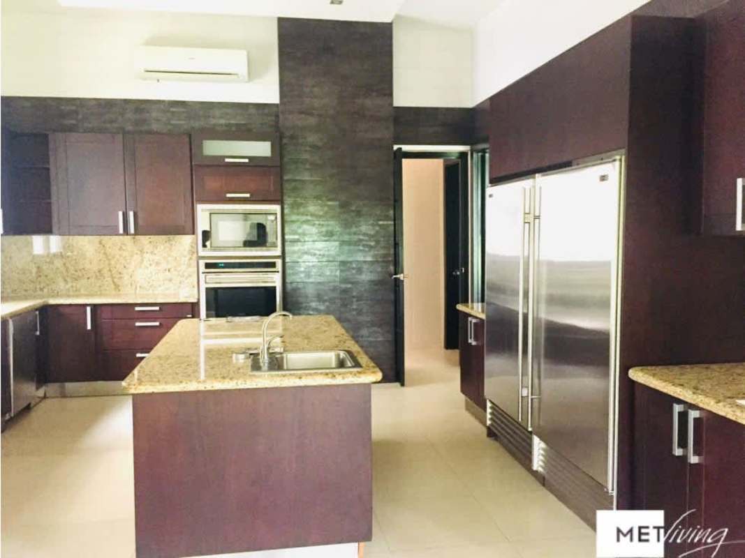 Spacious kitchen with granite countertops, kitchen island, and built-in appliances in Toscana Costa del Este villa