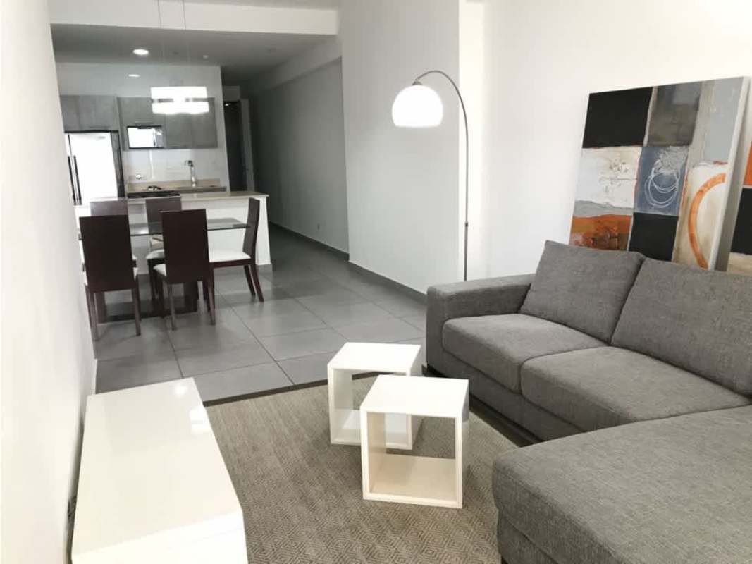 Open modern kitchen with island breakfast bar in PH Element condominium Panama City