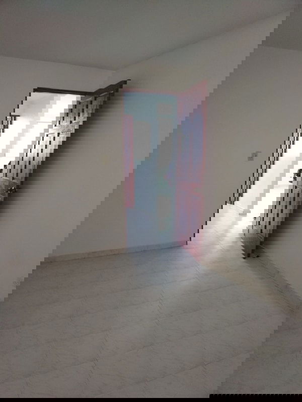 Bedroom with white tile floors, wooden door in PH La Cresta Residence Bella Vista Panama