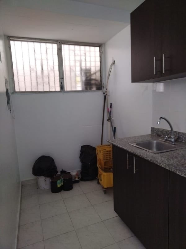 Laundry with granite countertop cabinetry barred window PH La Cresta Panama City