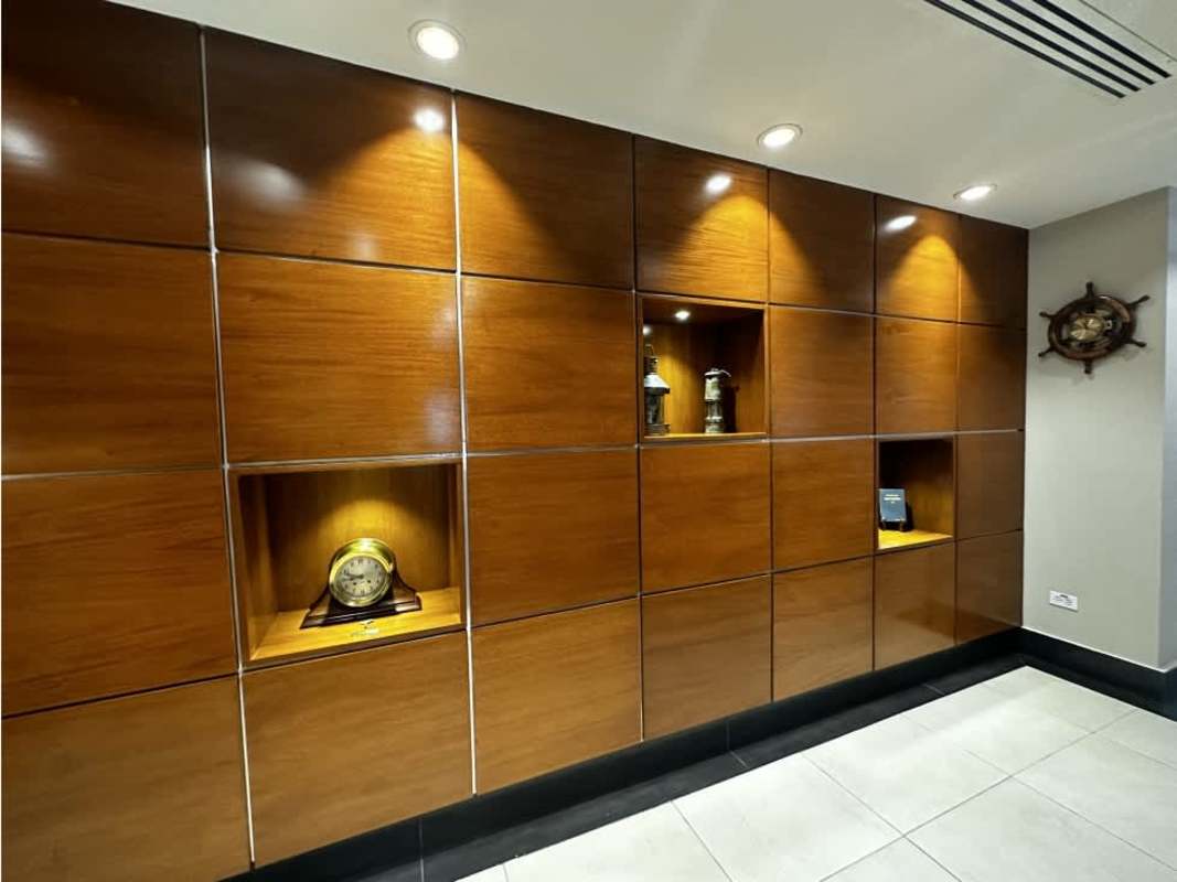 Modern lobby with wood panel recessed wall, spotlights and marble floor Scotia Plaza Panama