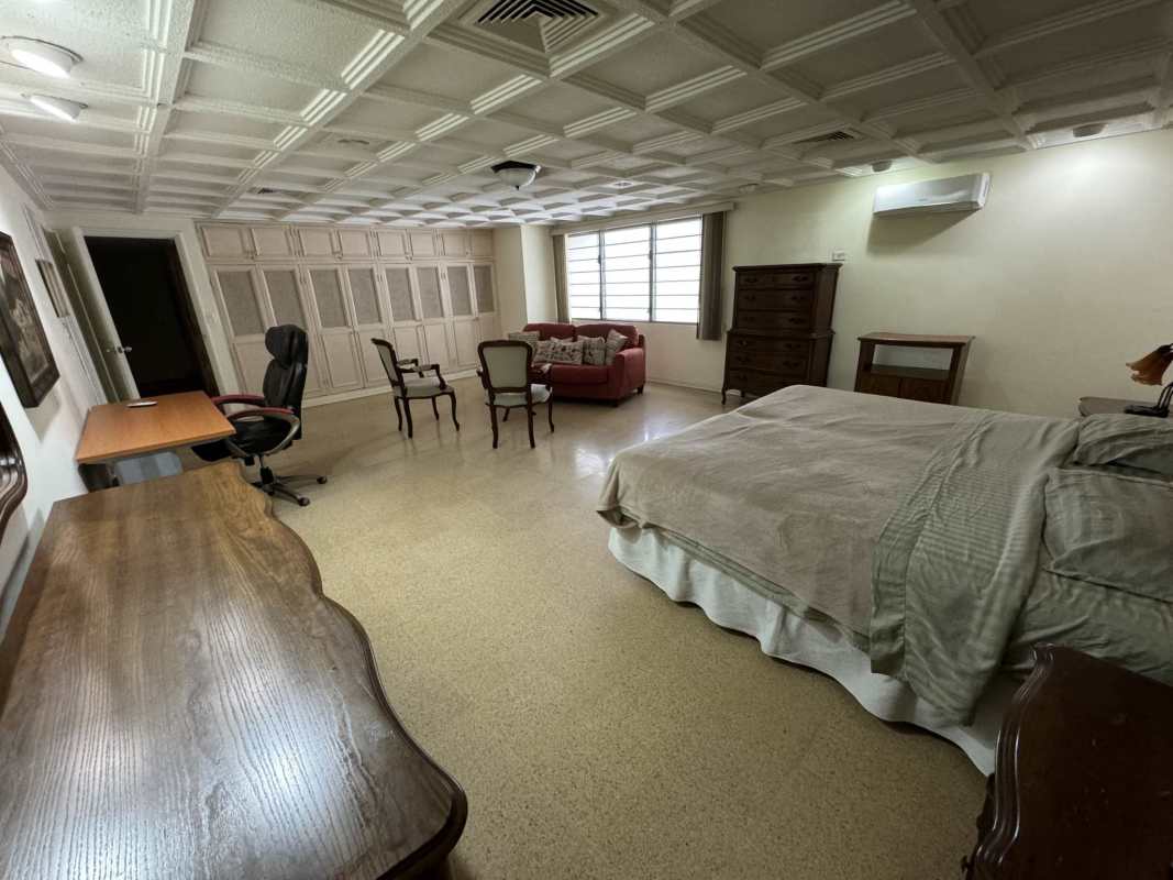 Living room with large windows opening to pool terrace in San Francisco Panama house