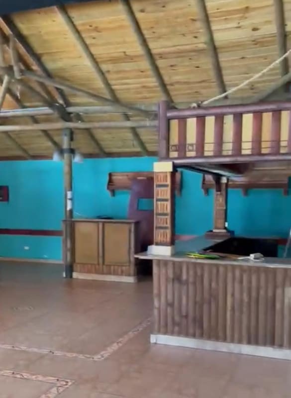 Rustic interior with bar counter turquoise walls wooden ceiling commercial unit Panama City