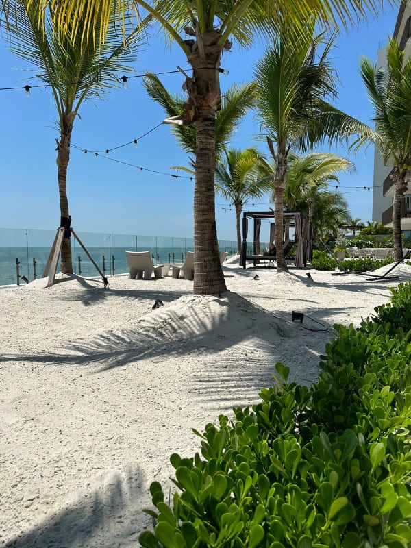 Luxurious beachfront area with palm trees hammock and white sand on Ocean Reef Islands Panama City