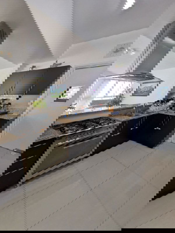 Spacious kitchen with granite countertops and appliances in PH San Francisco Bay Panama