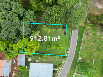 Two labeled commercial plots on highway with mountain backdrop in Chame Panama Oeste