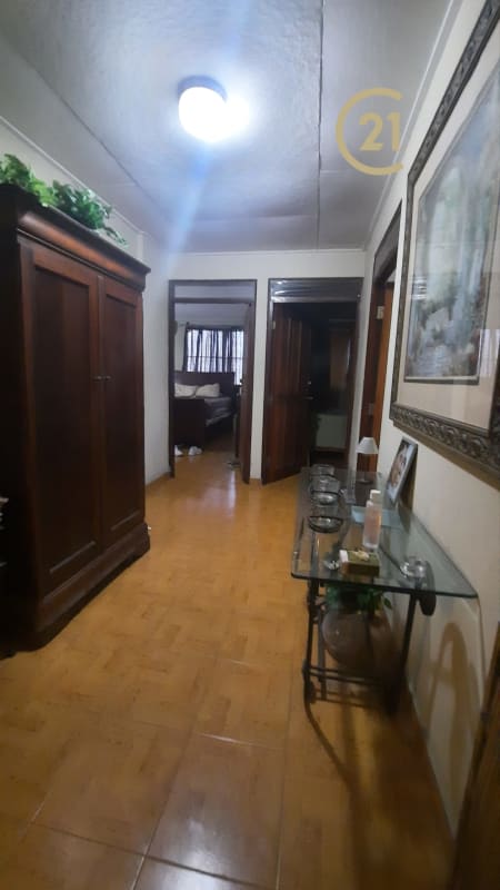 Wide hallway with wood floors and traditional decor inside house for sale Parque Lefevre Panama