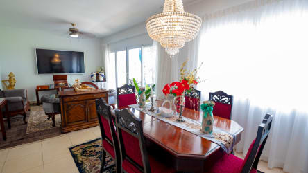 Traditional dining living room with chandelier, tile floors, and natural lighting PH Tucan Panama