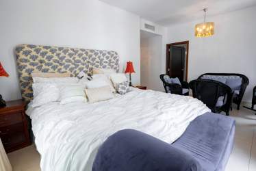 Spacious master bedroom featuring glass door to balcony with golf views at PH Tucan Country Club Panama