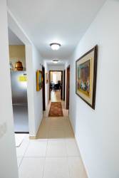 Living dining room with glass doors, vintage furniture, natural light at PH Tucan Panama Pacifico