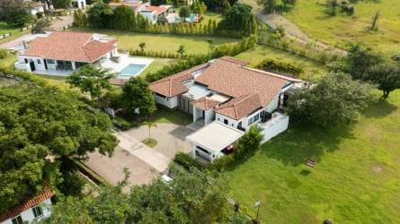 Bright open dining and kitchen area with large windows in Punta Barco Village luxury house