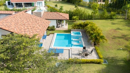 Aerial photo of beach house with swimming pool and tropical gardens Punta Barco Village Panama