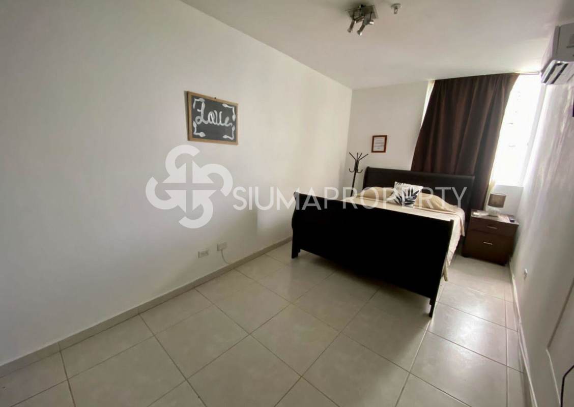 Bright bedroom with tile flooring, large closet and ocean view window in PH Bay View Panama