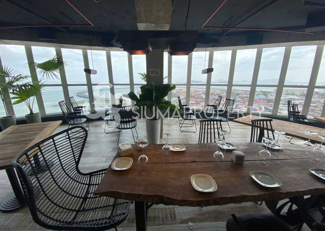 Dining lounge with ocean city views floor-to-ceiling windows in PH Bay View