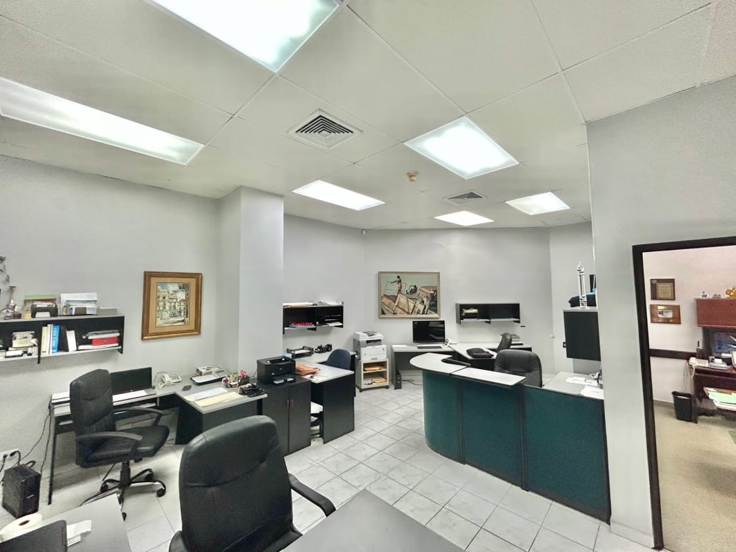 Private enclosed office with wooden desk, certificates wall inside commercial office San Francisco Plaza