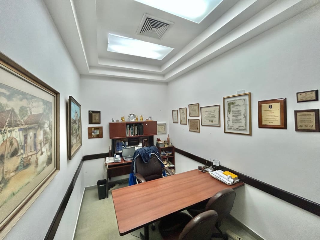 Large shared office workspace with multiple desks and equipment inside commercial unit San Francisco Plaza