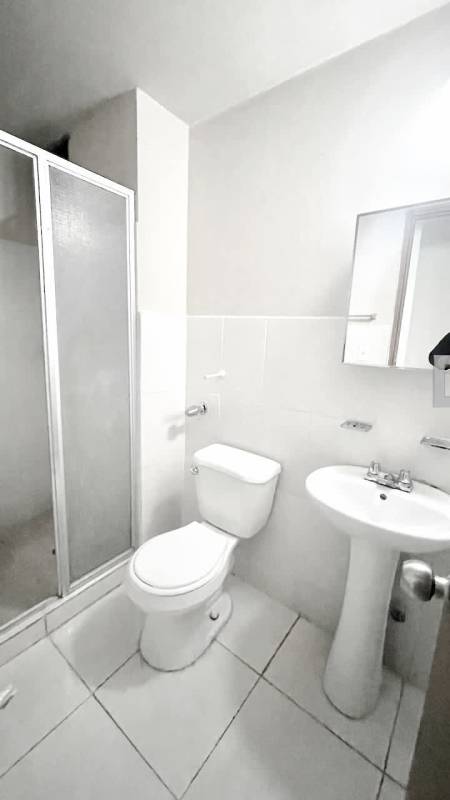 Modern bathroom with walk-in shower and pedestal sink in PH Residencial Llano Bonito Panama
