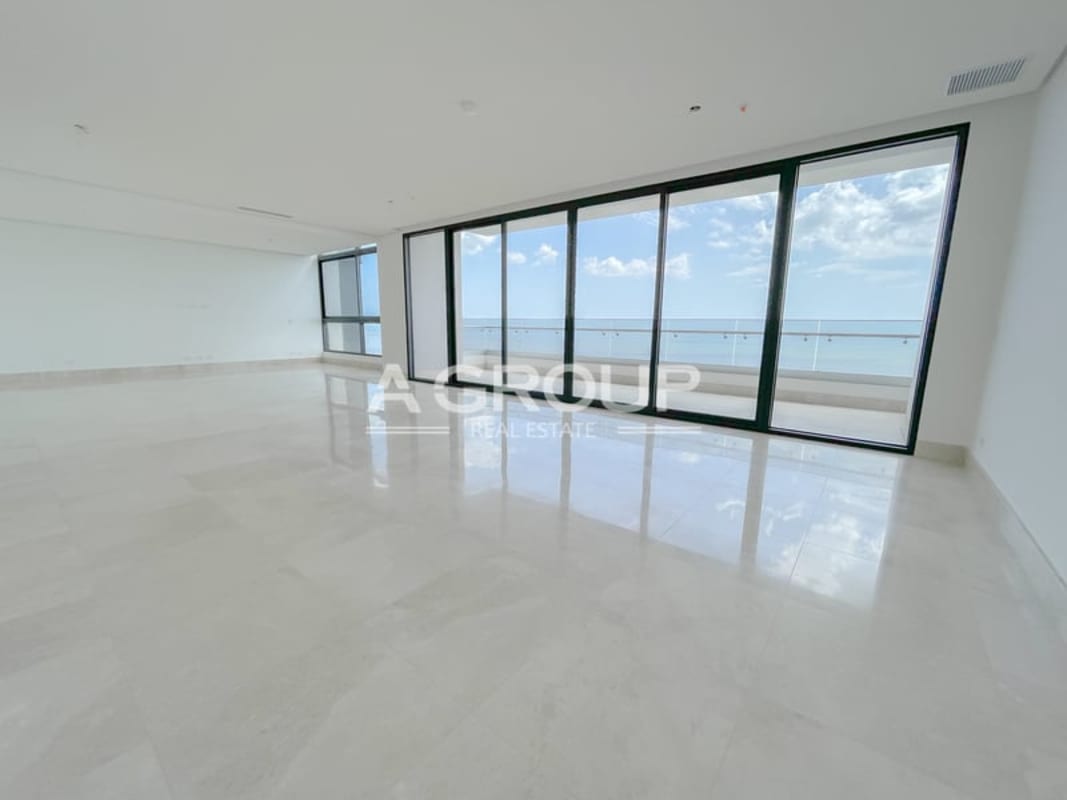 Living room in luxury condo PH Matisse Costa del Este with marble floors and full-height windows ocean view