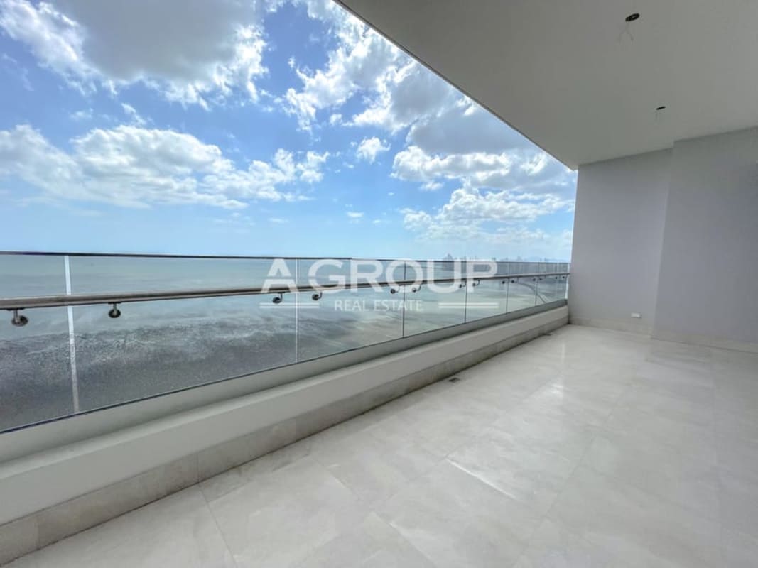Bright spacious living room with large windows and ocean view in PH Matisse Costa del Este Panama