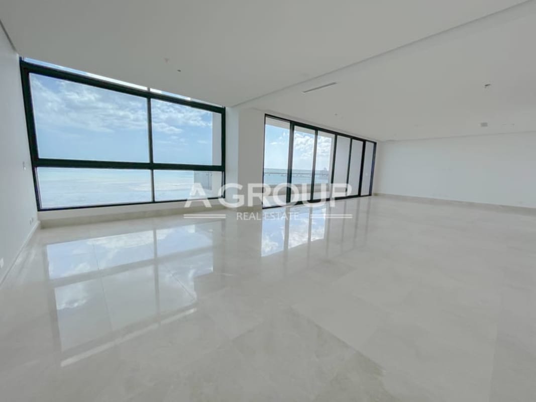 Spacious luxury apartment living room with panoramic glass wall facing the ocean PH Matisse Panama City