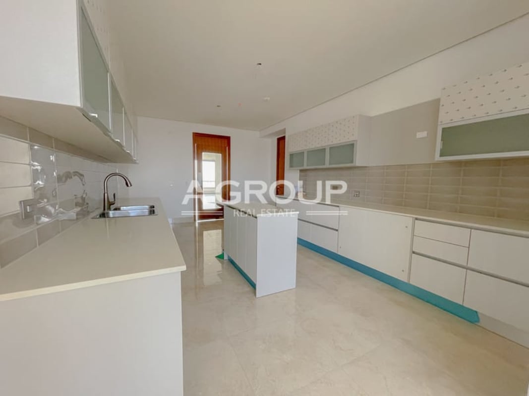Spacious modern kitchen with island granite counter built-in cabinets PH Matisse Costa del Este apartment