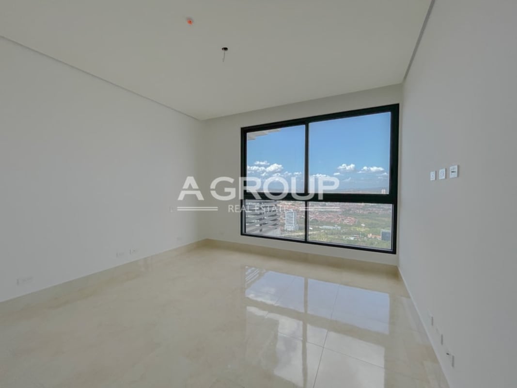 Spacious minimalist bedroom with floor-to-ceiling windows and city view PH Matisse Costa del Este Panama