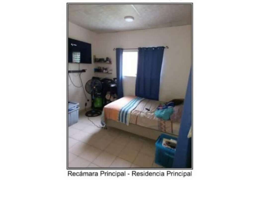 Simple master bedroom with bed, blue curtains, wall shelves Don Bosco Panama City