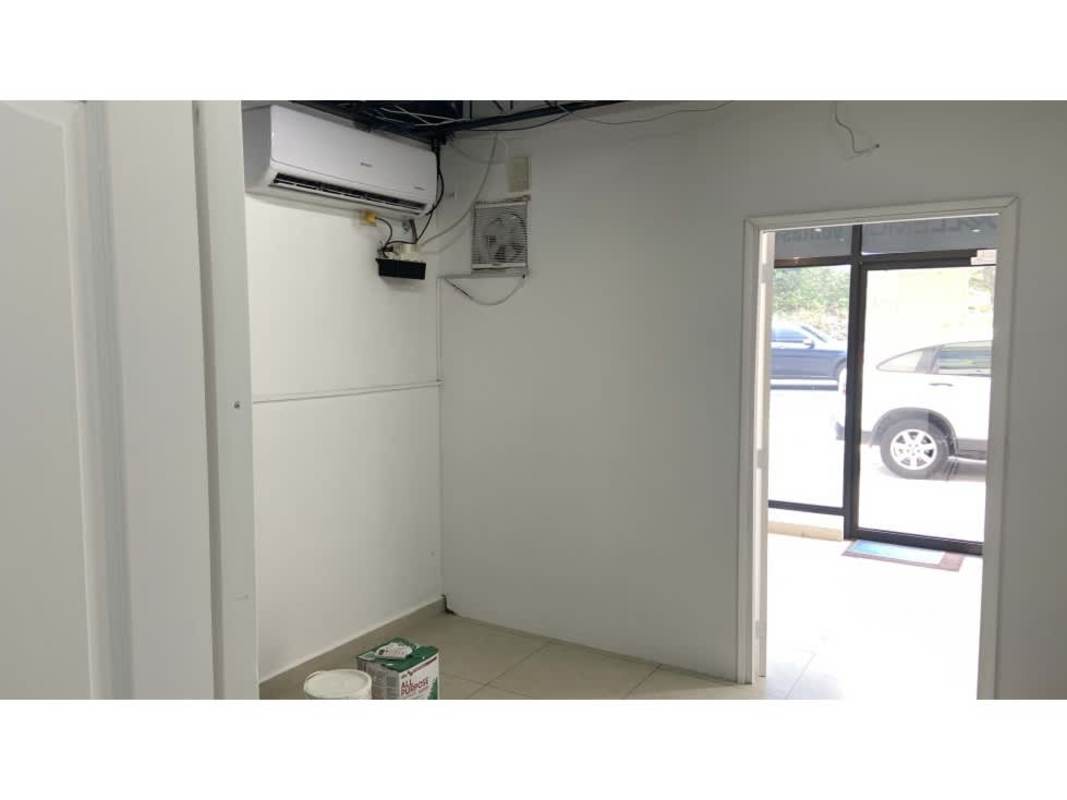 Storefront commercial plaza with large windows and parking area, Parque Lefevre Panama City