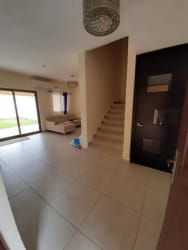 Open-plan living room with tiled floor and sliding doors to covered terrace in Panama Pacifico