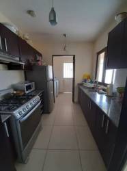 Dining room with tile floors and sliding glass overlooking garden terrace Panama Pacifico