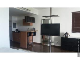 Dining table and lounge space in furnished studio at Town Center Playa Blanca