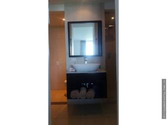 Multi-story beach condo at Town Center Playa Blanca with balconies and palm trees