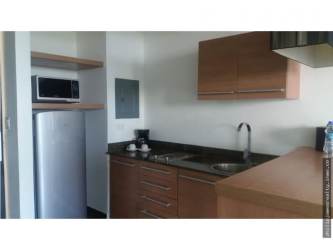 Open-plan furnished studio with beds, kitchenette, dining and balcony Playa Blanca