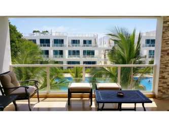 Living room with sliding glass doors, balcony access, tropical views in Playa Blanca Panama