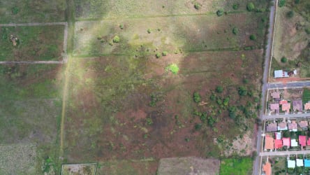 Aerial of open plot next to residential neighborhood Aguadulce Panama