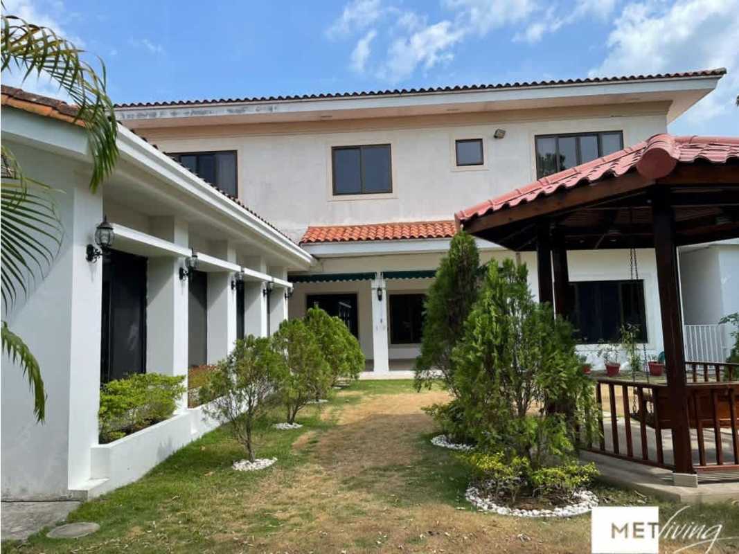 Spacious kitchen with wood cabinets, granite counters and stainless appliances in luxury house Panama