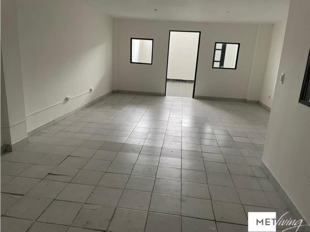 Open interior space with industrial staircase and mezzanine in Plaza Carolina Chanis Panama City