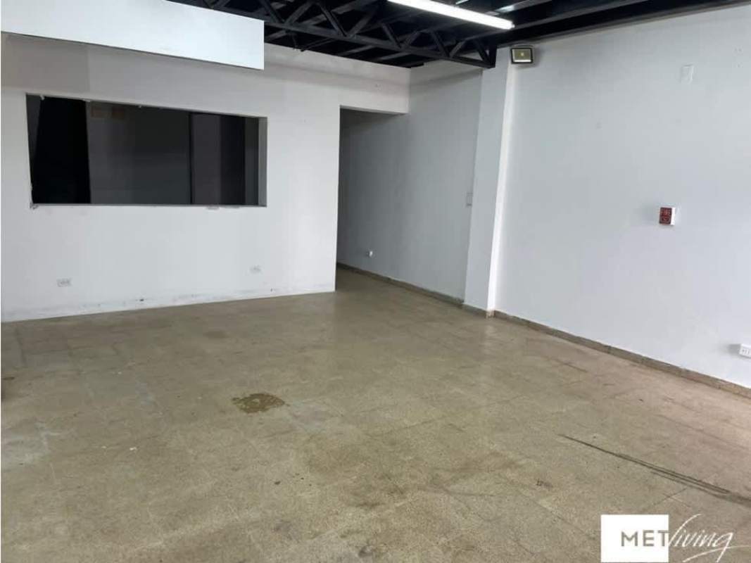Open retail or warehouse area with white walls and exposed beams Plaza Carolina Panama