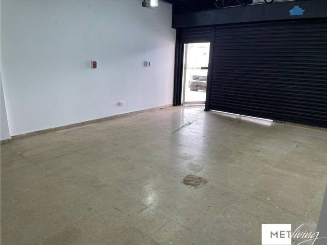 Black metal staircase leading to mezzanine inside commercial property in Plaza Carolina Panama for sale